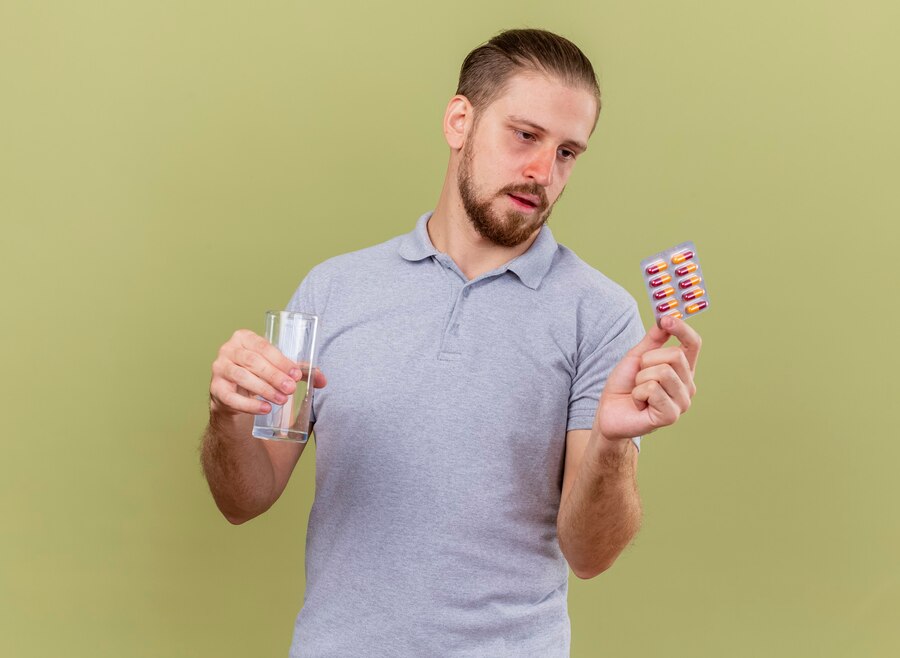 Man taking supplements for hair loss